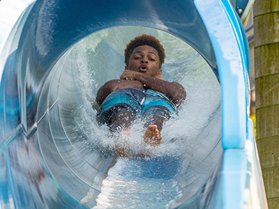 Boy sliding down waterslide